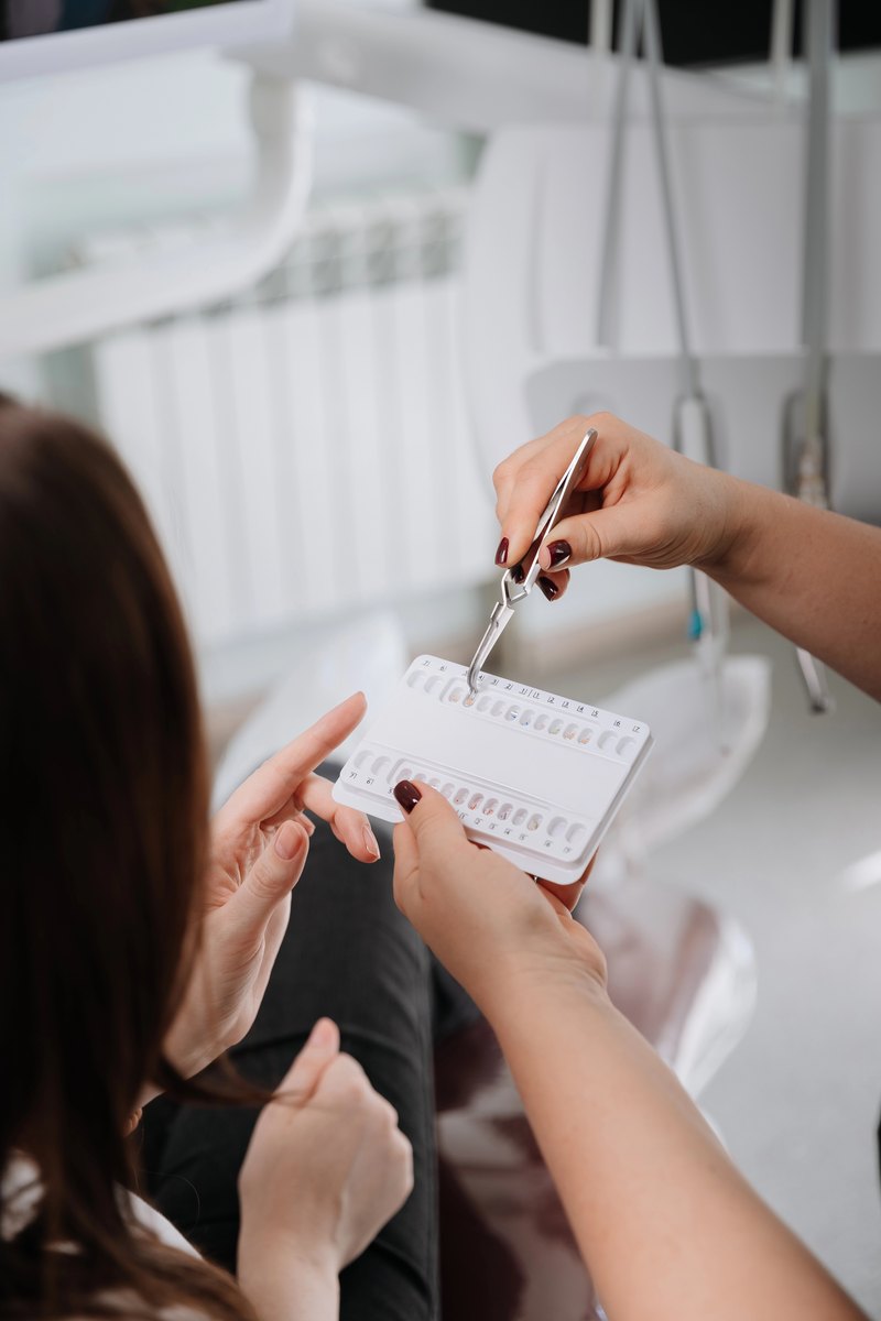 Dentist using a tooth shade guide with a patient