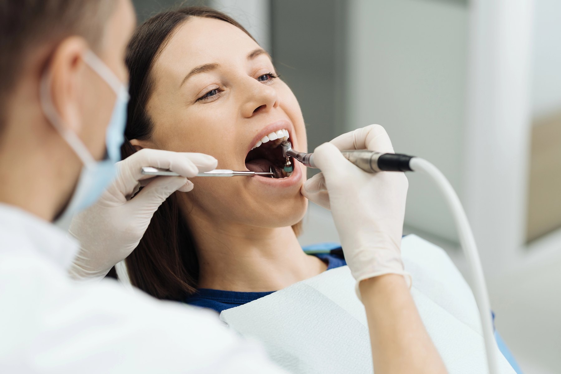 Dental professional performing a teeth cleaning