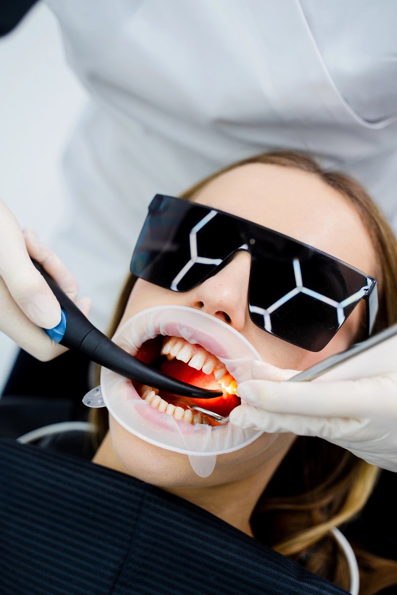 Dental professional examining a patient’s mouth