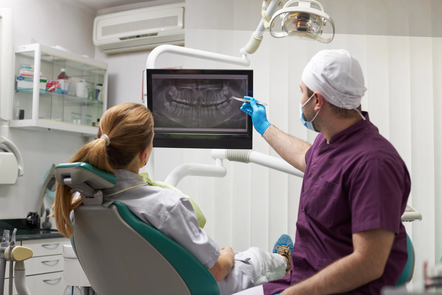 Orthodontist reviewing a patient’s teeth