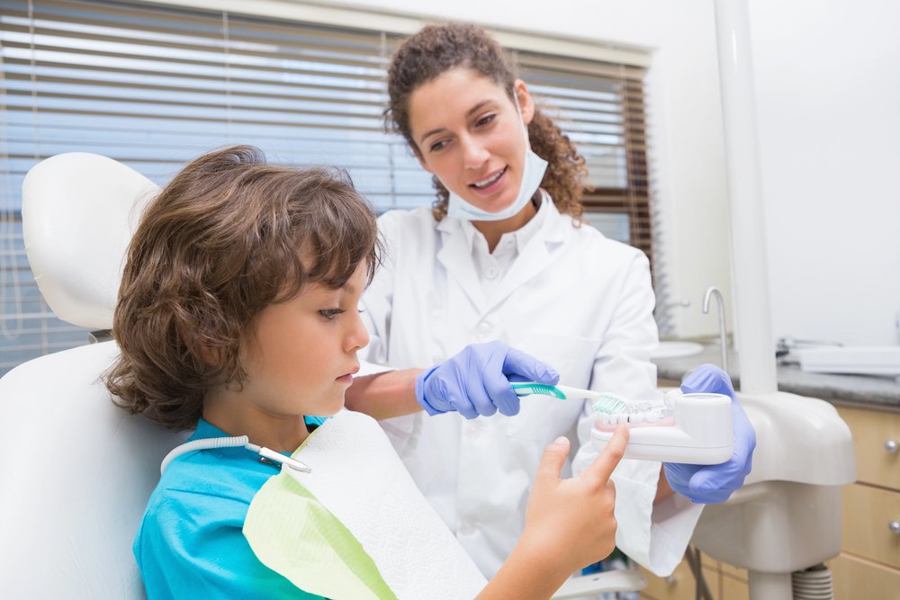 Pediatric dentist examining a child
